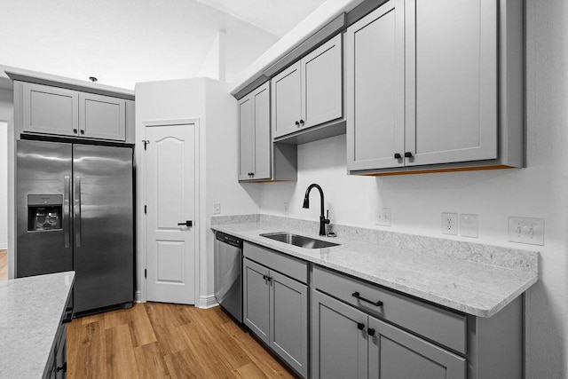 516 Vulpes Sanctuary Loop, Crestview, FL 32536 - kitchen with stainless steel appliances, gray cabinets, a sink, and light wood-style flooring