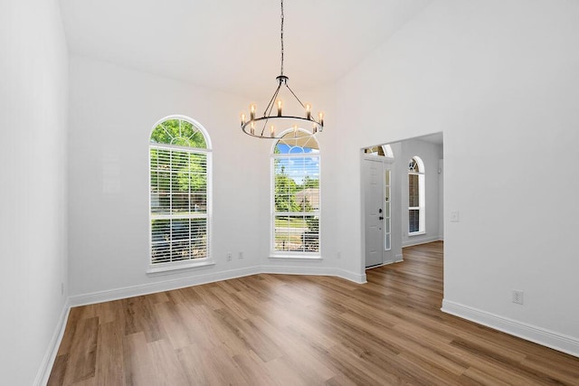516 Vulpes Sanctuary Loop, Crestview, FL 32536 - unfurnished dining area with a chandelier, wood finished floors, and baseboards