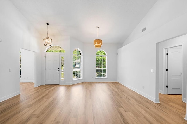 516 Vulpes Sanctuary Loop, Crestview, FL 32536 - entryway with light wood-style flooring, baseboards, a chandelier, and high vaulted ceiling