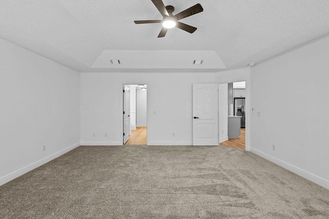 516 Vulpes Sanctuary Loop, Crestview, FL 32536 - unfurnished bedroom featuring stainless steel refrigerator with ice dispenser, light colored carpet, baseboards, and a textured ceiling