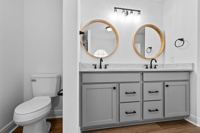 516 Vulpes Sanctuary Loop, Crestview, FL 32536 - bathroom with double vanity, wood finished floors, toilet, and baseboards