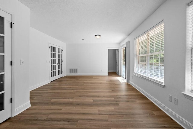 516 Vulpes Sanctuary Loop, Crestview, FL 32536 - unfurnished room featuring a textured ceiling, dark wood-style floors, and baseboards