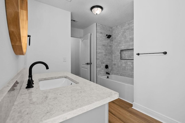 516 Vulpes Sanctuary Loop, Crestview, FL 32536 - full bath featuring vanity, wood finished floors, shower / bathtub combination, and a textured ceiling