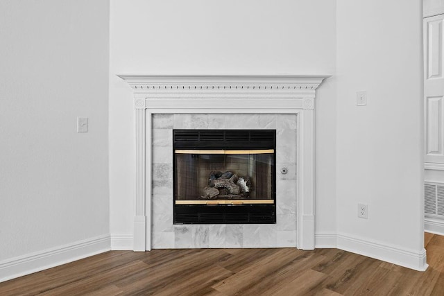 516 Vulpes Sanctuary Loop, Crestview, FL 32536 - detailed view of wood finished floors, baseboards, and a high end fireplace