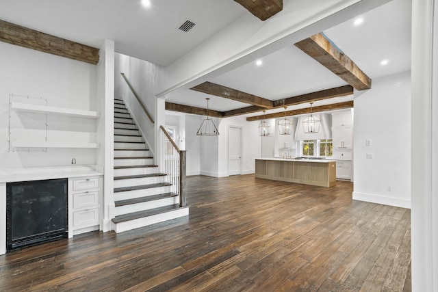 80 Shore Bridge Cir, Inlet Beach, FL 32461 - unfurnished living room featuring beamed ceiling, beverage cooler, dark wood-style flooring, stairs, and baseboards