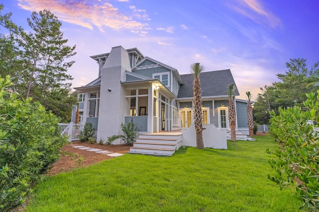 80 Shore Bridge Cir, Inlet Beach, FL 32461 - back of property at dusk featuring a yard and a sunroom