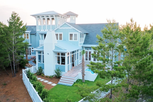 80 Shore Bridge Cir, Inlet Beach, FL 32461 - back of house featuring roof with shingles, board and batten siding, stairway, and a sunroom