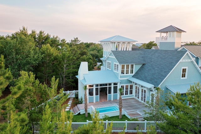 80 Shore Bridge Cir, Inlet Beach, FL 32461 - rear view of house with a fenced front yard, roof with shingles, and a deck