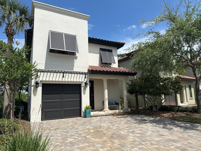 1893 Baytowne Loop, Miramar Beach, FL 32550 - view of front facade featuring a garage, a tiled roof, stucco siding, and decorative driveway
