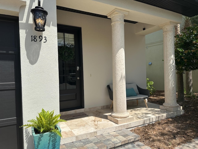 1893 Baytowne Loop, Miramar Beach, FL 32550 - doorway to property featuring a porch and stucco siding