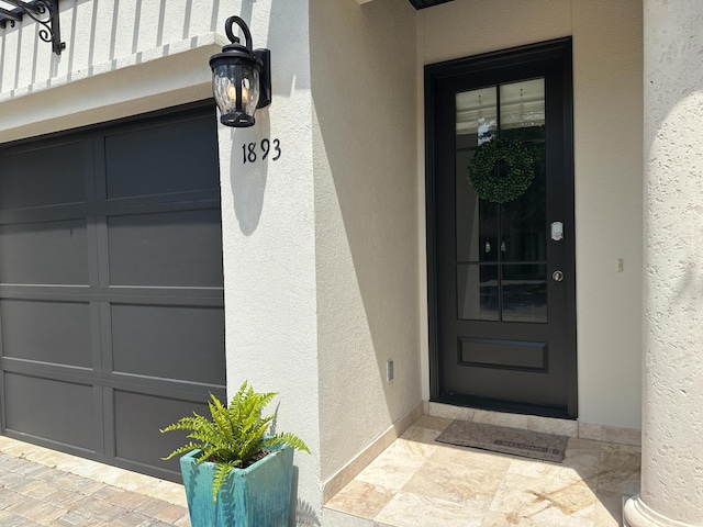 1893 Baytowne Loop, Miramar Beach, FL 32550 - doorway to property with stucco siding and a garage