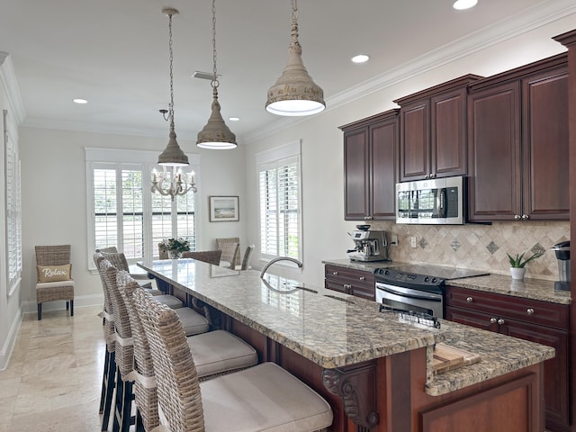 1893 Baytowne Loop, Miramar Beach, FL 32550 - kitchen featuring stainless steel appliances, a breakfast bar, tasteful backsplash, healthy amount of natural light, and recessed lighting