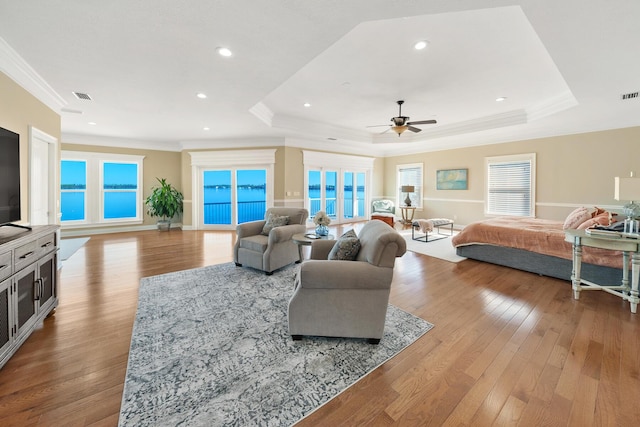 107 Alabama Ave, Lynn Haven, FL 32444 - living room featuring ceiling fan, a raised ceiling, light wood-style floors, crown molding, and baseboards