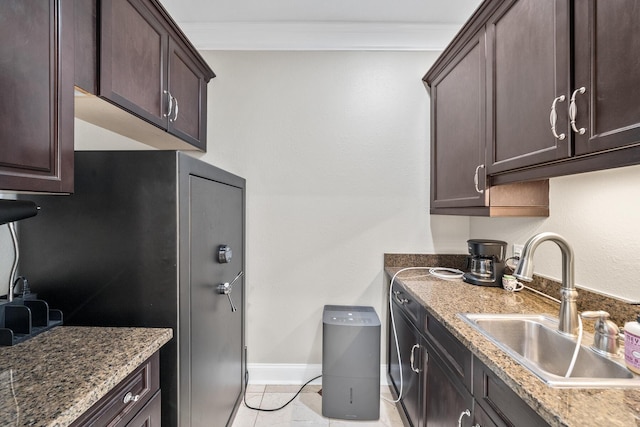 107 Alabama Ave, Lynn Haven, FL 32444 - kitchen with a sink, crown molding, dark brown cabinets, light tile patterned flooring, and stone counters