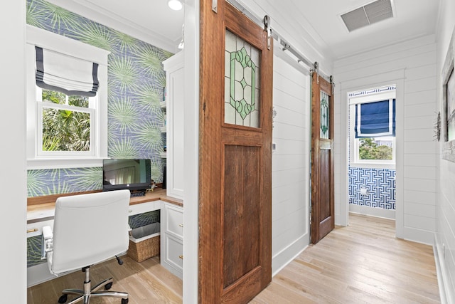 29 Tidal Bridge Way, Watersound, FL 32461 - office area featuring a barn door, light wood finished floors, and healthy amount of natural light