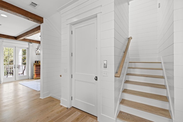 29 Tidal Bridge Way, Watersound, FL 32461 - staircase featuring wood finished floors, beamed ceiling, french doors, and wood walls