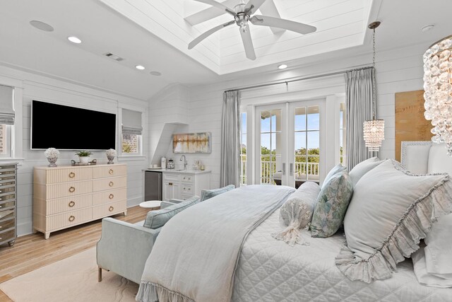 29 Tidal Bridge Way, Watersound, FL 32461 - bedroom featuring light wood-style flooring, access to exterior, a sink, freestanding refrigerator, and wood walls
