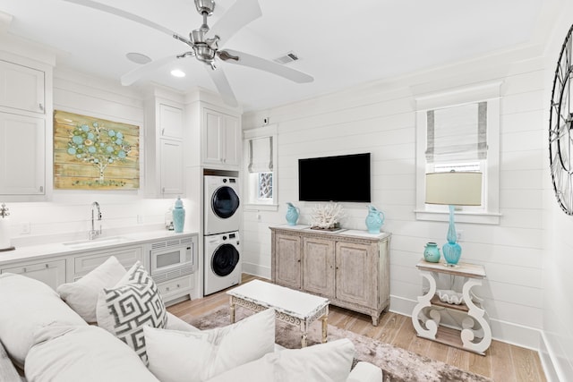 29 Tidal Bridge Way, Watersound, FL 32461 - living area featuring stacked washing machine and dryer, light wood-style flooring, ceiling fan, recessed lighting, and baseboards