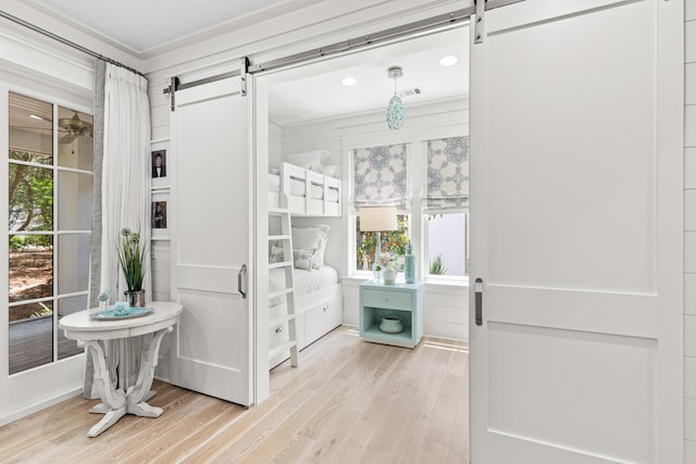 29 Tidal Bridge Way, Watersound, FL 32461 - foyer featuring a barn door, wood finished floors, healthy amount of natural light, ornamental molding, and recessed lighting