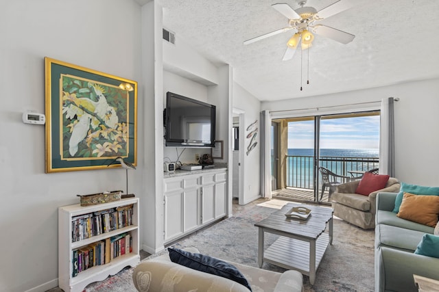 3692 E County Highway 30a Unit 9, Santa Rosa Beach, FL 32459 - living room with a textured ceiling, ceiling fan, and baseboards