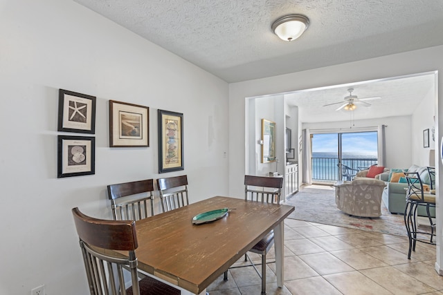 3692 E County Highway 30a Unit 9, Santa Rosa Beach, FL 32459 - dining area with a ceiling fan, a textured ceiling, and light tile patterned flooring
