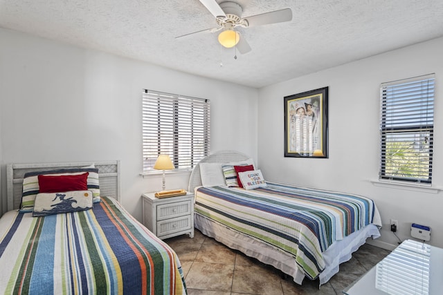 3692 E County Highway 30a Unit 9, Santa Rosa Beach, FL 32459 - bedroom featuring multiple windows, a textured ceiling, ceiling fan, baseboards, and tile patterned floors