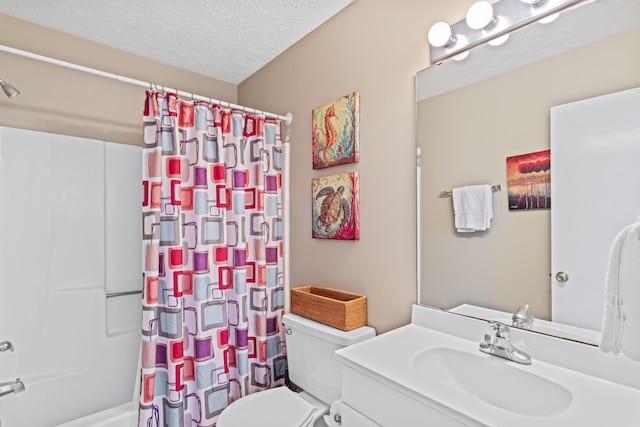 3692 E County Highway 30a Unit 9, Santa Rosa Beach, FL 32459 - bathroom with toilet, vanity, shower / bath combo, and a textured ceiling