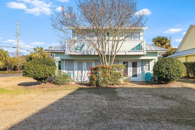 114 Mainsail Dr Unit C28, Miramar Beach, FL 32550 - rear view of property featuring french doors, stucco siding, metal roof, and a yard