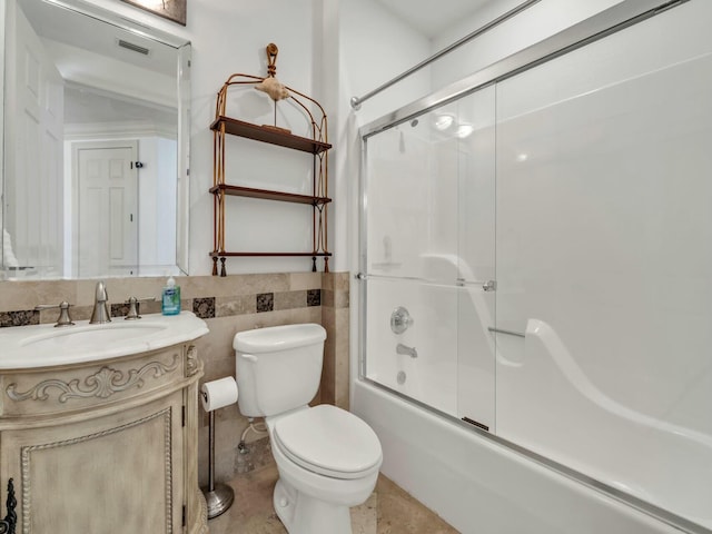 602 Harbor Blvd Unit 201, Destin, FL 32541 - full bathroom featuring vanity, toilet, combined bath / shower with glass door, and tile walls