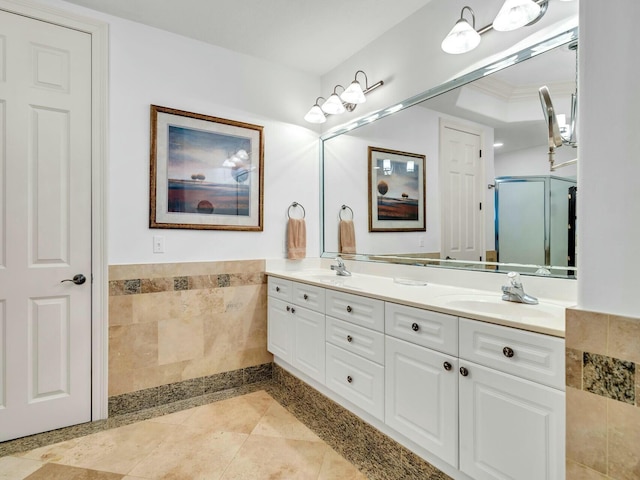 602 Harbor Blvd Unit 201, Destin, FL 32541 - full bathroom with double vanity, a shower with door, tile walls, wainscoting, and tile patterned flooring