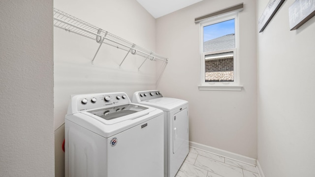 880 Lowery Dr, Fort Walton Beach, FL 32547 - laundry room featuring washing machine and clothes dryer, light marble finish flooring, and baseboards