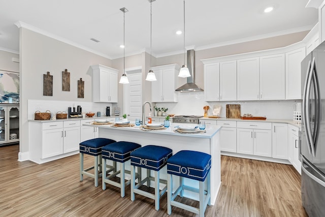 0000 E Bayou Forest Dr Lot 21, Freeport, FL 32439 - kitchen with wall chimney exhaust hood, light wood-style flooring, backsplash, crown molding, and recessed lighting