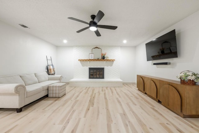 538 22nd St, Niceville, FL 32578 - living room with light wood finished floors, a brick fireplace, ceiling fan, and recessed lighting