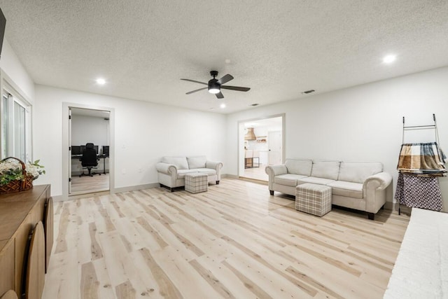 538 22nd St, Niceville, FL 32578 - living room with light wood-style floors, recessed lighting, ceiling fan, a textured ceiling, and a desk
