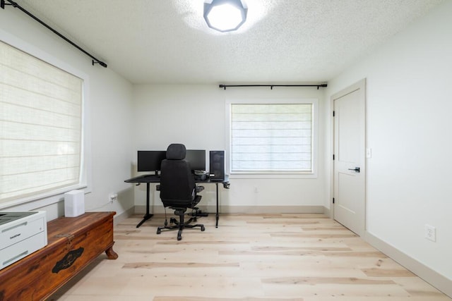 538 22nd St, Niceville, FL 32578 - home office with a textured ceiling, wood finished floors, plenty of natural light, and baseboards