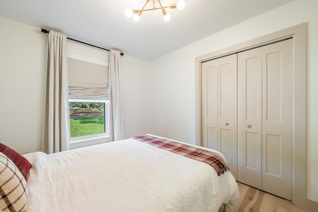 538 22nd St, Niceville, FL 32578 - bedroom with light wood-type flooring, a chandelier, and a closet