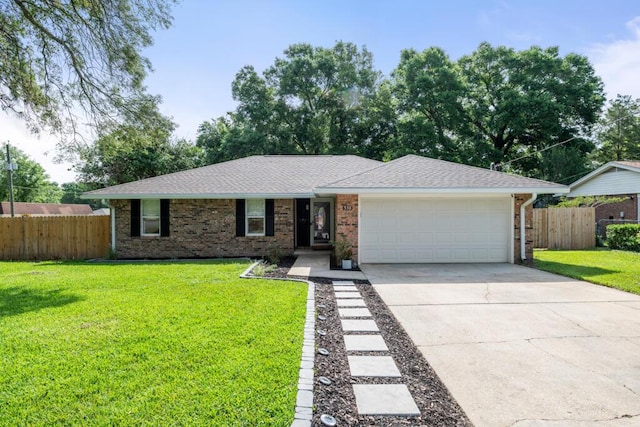 538 22nd St, Niceville, FL 32578 - ranch-style house with an attached garage, driveway, brick siding, and a shingled roof