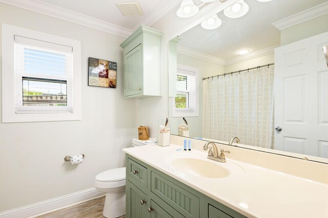 104 Derondo St, Panama City Beach, FL 32413 - full bath featuring baseboards, toilet, vanity, ornamental molding, and wood finished floors