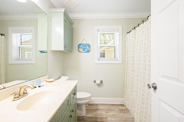 104 Derondo St, Panama City Beach, FL 32413 - full bathroom with ornamental molding, wood finished floors, toilet, vanity, and baseboards