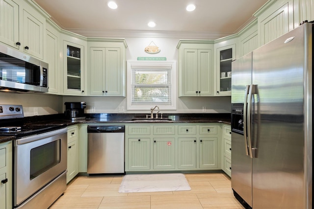 104 Derondo St, Panama City Beach, FL 32413 - kitchen featuring appliances with stainless steel finishes, a sink, green cabinets, glass insert cabinets, and recessed lighting