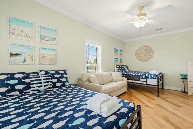 104 Derondo St, Panama City Beach, FL 32413 - bedroom with ornamental molding, wood finished floors, a ceiling fan, and baseboards