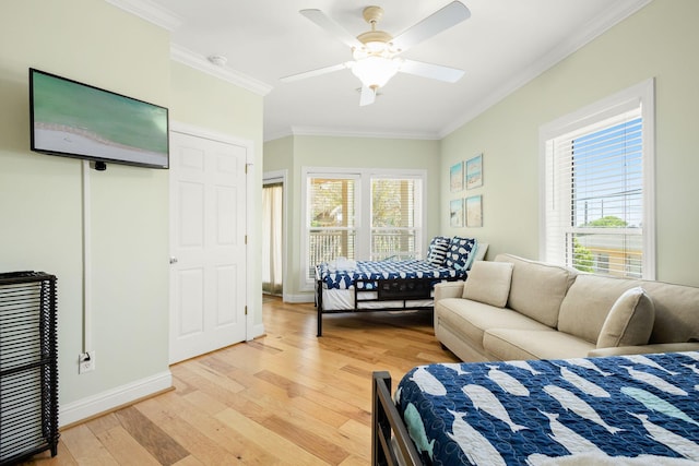 104 Derondo St, Panama City Beach, FL 32413 - bedroom with ornamental molding, light wood finished floors, multiple windows, baseboards, and ceiling fan