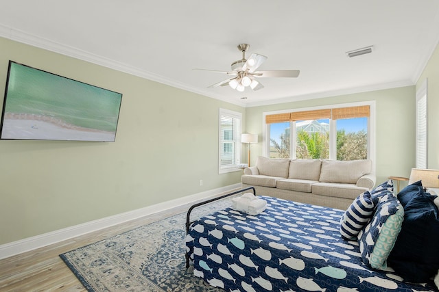 104 Derondo St, Panama City Beach, FL 32413 - bedroom with baseboards, wood finished floors, ornamental molding, and a ceiling fan