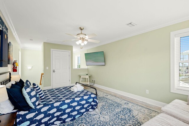 104 Derondo St, Panama City Beach, FL 32413 - bedroom with ornamental molding, baseboards, wood finished floors, and a ceiling fan