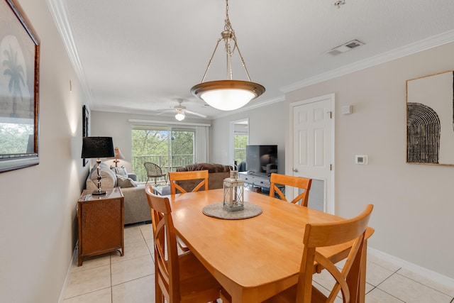 4270 Calinda Ln Unit 343, Niceville, FL 32578 - dining area with crown molding, light tile patterned floors, baseboards, and ceiling fan