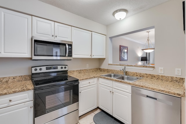 4270 Calinda Ln Unit 343, Niceville, FL 32578 - kitchen featuring stainless steel appliances, a sink, white cabinets, a textured ceiling, and ornamental molding