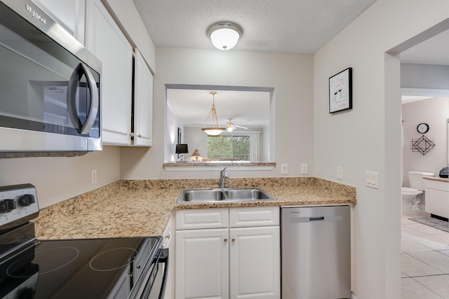 4270 Calinda Ln Unit 343, Niceville, FL 32578 - kitchen featuring appliances with stainless steel finishes, a sink, white cabinets, light countertops, and a textured ceiling