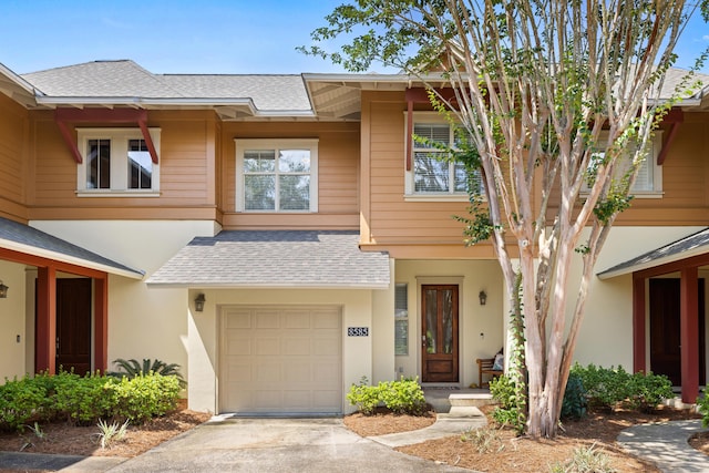 8585 Magnolia Bay Ln, Miramar Beach, FL 32550 - townhome / multi-family property with an attached garage, roof with shingles, concrete driveway, and stucco siding