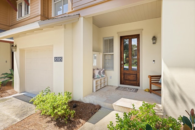 8585 Magnolia Bay Ln, Miramar Beach, FL 32550 - doorway to property featuring stucco siding, a garage, and french doors