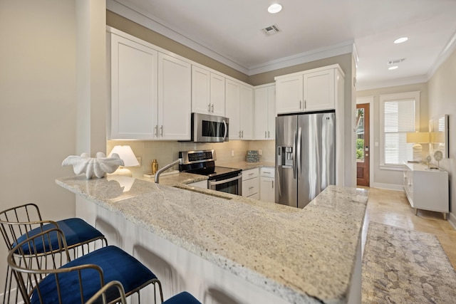 8585 Magnolia Bay Ln, Miramar Beach, FL 32550 - kitchen with appliances with stainless steel finishes, light stone countertops, decorative backsplash, recessed lighting, and ornamental molding